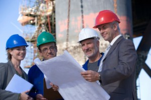 92411270- 4 people in different hard hats on site